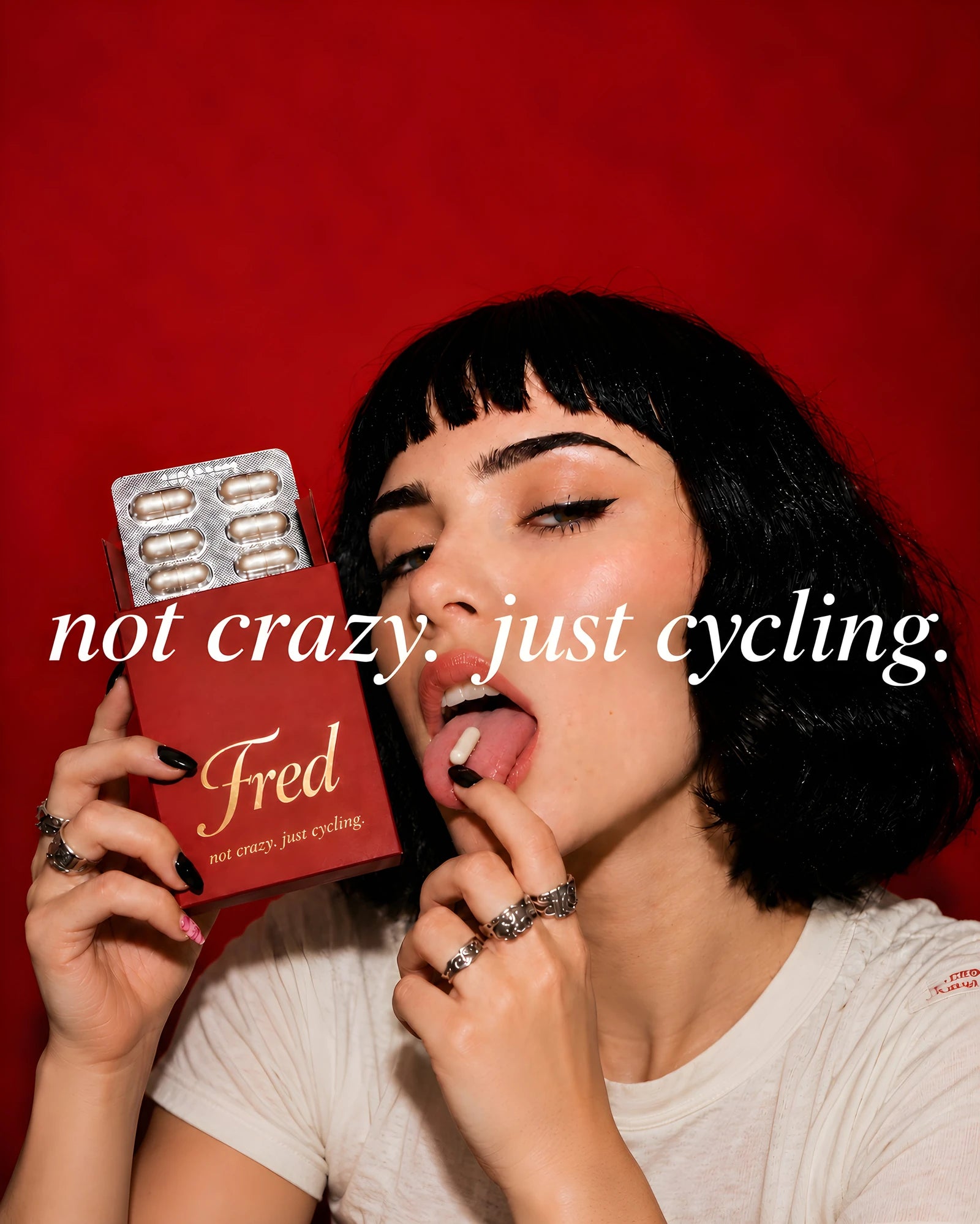 a woman with a fred box, about to take a capsule. not crazy. just cycling.
